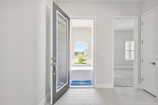 foyer entrance with light hardwood / wood-style floors