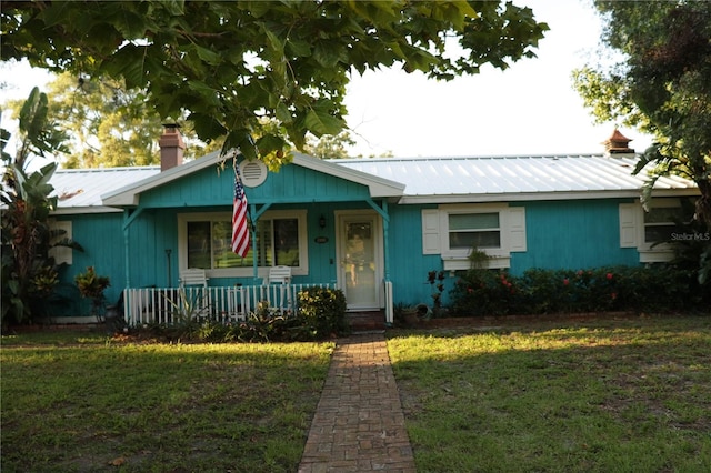 ranch-style home with a front yard and a porch