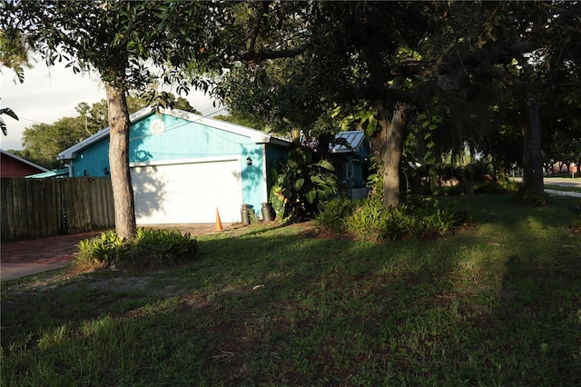 exterior space featuring a yard and a garage