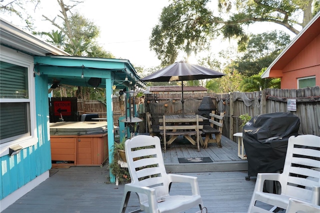 wooden deck featuring grilling area and a hot tub