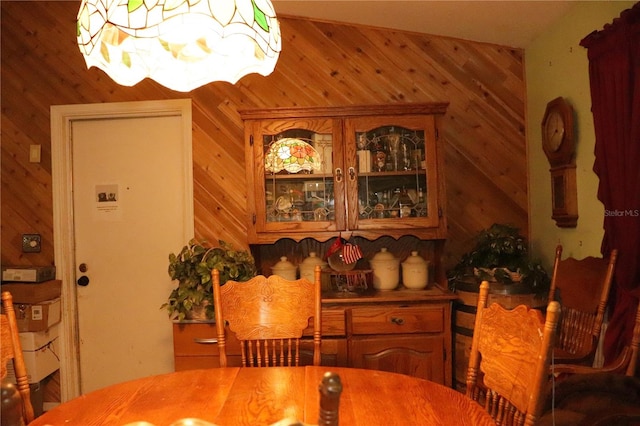 dining room featuring wooden walls