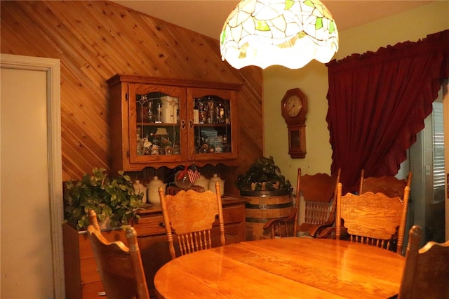 dining space with wood walls