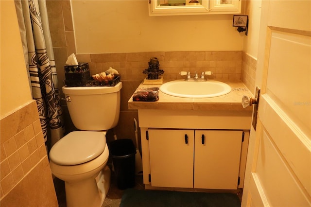 bathroom with tile walls, backsplash, toilet, and vanity