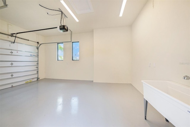 garage featuring sink and a garage door opener