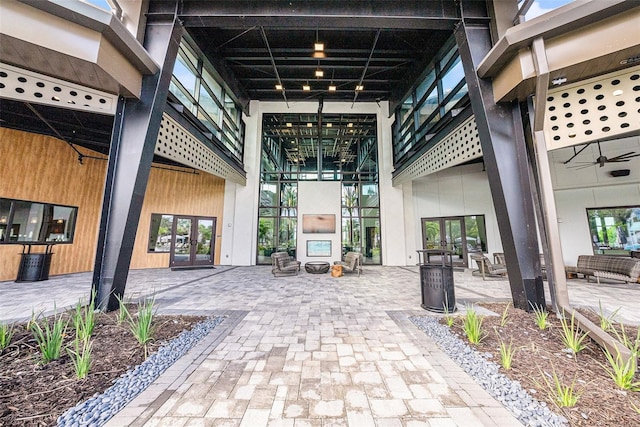 property entrance featuring a patio area, ceiling fan, and french doors