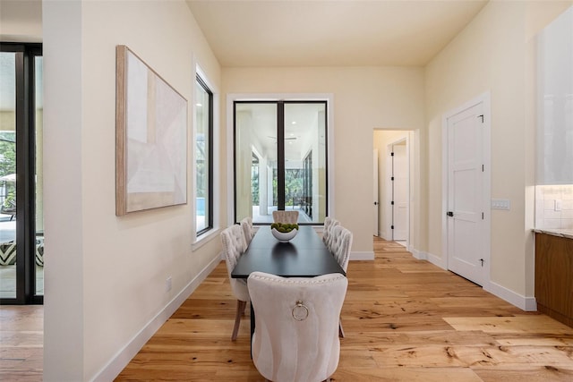 dining space with light hardwood / wood-style floors