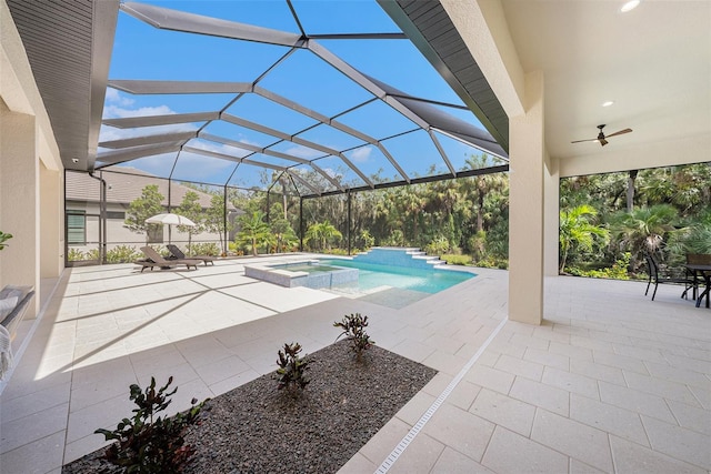 view of swimming pool featuring a lanai, a patio area, ceiling fan, and an in ground hot tub