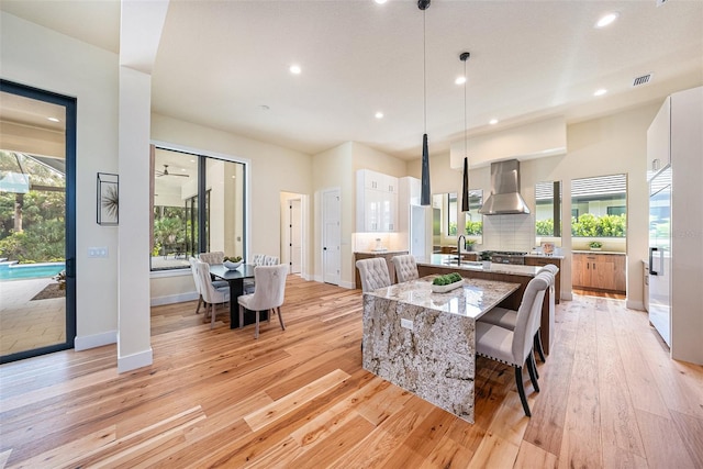 dining room with sink and light wood-type flooring