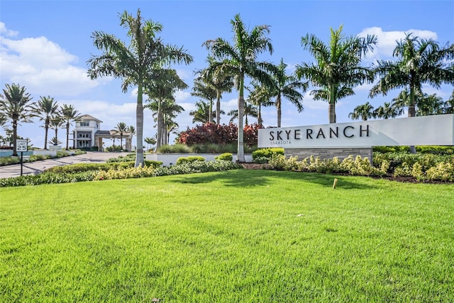 community sign featuring a yard