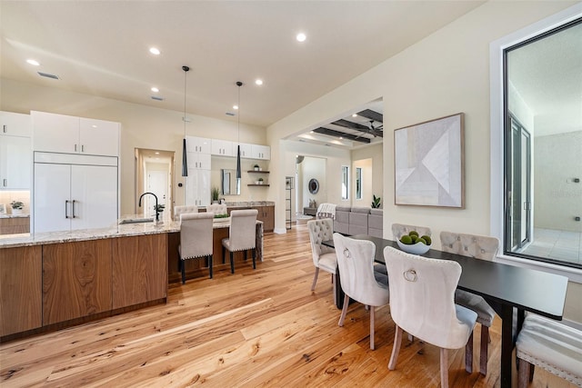 dining area featuring sink and light hardwood / wood-style flooring