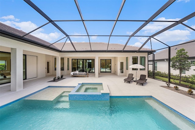 back of property with a lanai, a pool with hot tub, and a patio area