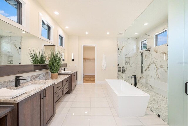 bathroom featuring tile patterned floors, vanity, and separate shower and tub