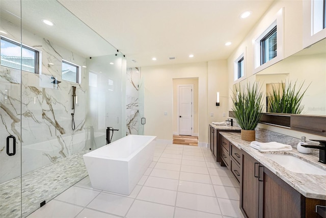 bathroom with independent shower and bath, vanity, and tile patterned floors