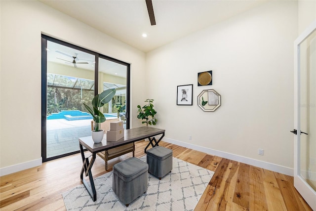 office space with ceiling fan and light wood-type flooring