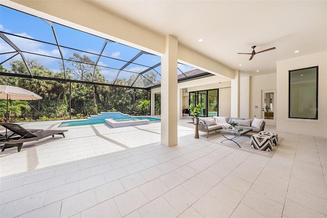 view of pool featuring a patio, outdoor lounge area, ceiling fan, and glass enclosure