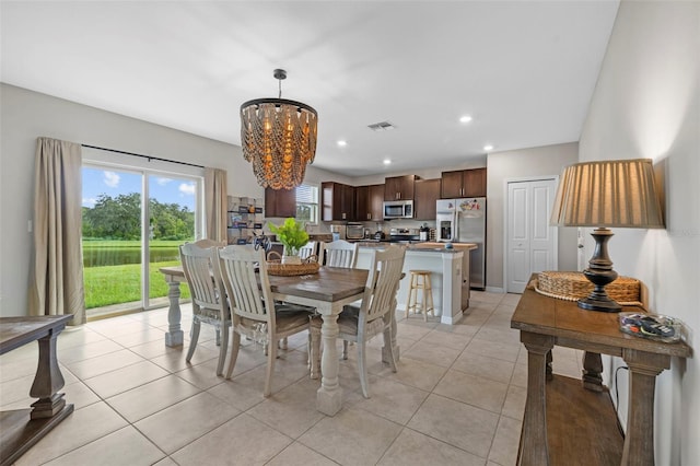 dining room featuring light tile patterned floors and a notable chandelier