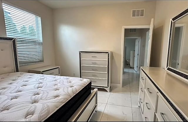 bedroom featuring light tile patterned flooring