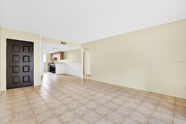 unfurnished living room with light tile patterned flooring