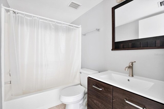 full bathroom with tile patterned flooring, toilet, vanity, and shower / bathtub combination with curtain