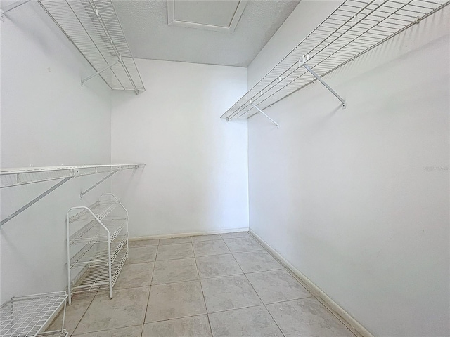 walk in closet featuring light tile patterned floors