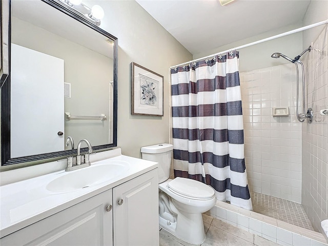 bathroom with tile patterned floors, toilet, vanity, and a shower with curtain