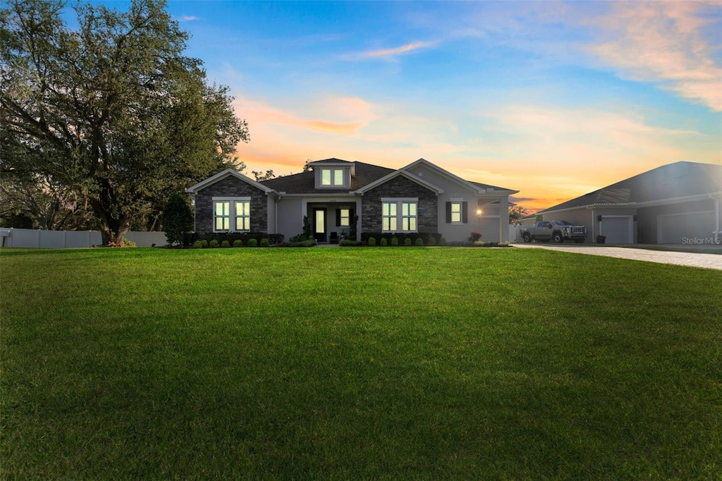 view of front facade featuring a garage and a lawn