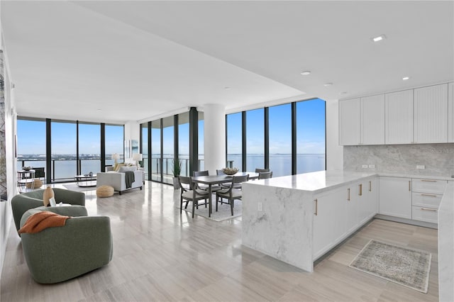 kitchen with a healthy amount of sunlight, expansive windows, and tasteful backsplash