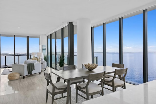 dining space with plenty of natural light, expansive windows, and a water view