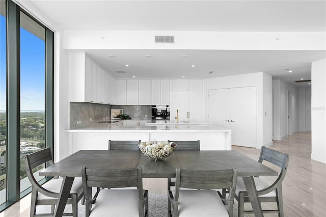 dining area with a wall of windows