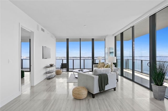 living room with floor to ceiling windows and a water view