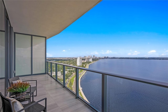 balcony with a water view and a city view