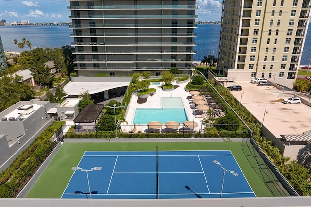 exterior space featuring a community pool and a water view