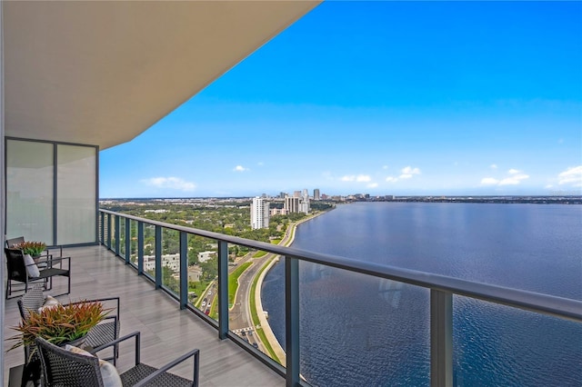 balcony with a water view and a city view