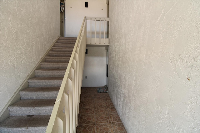 stairs with tile patterned flooring