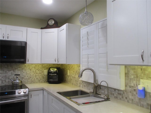 kitchen featuring sink, decorative backsplash, white cabinets, and stainless steel appliances