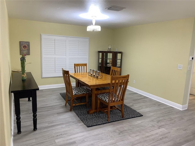 dining room with light hardwood / wood-style flooring