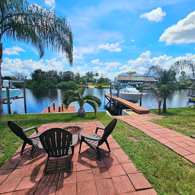 view of patio / terrace featuring a boat dock, a water view, and an outdoor fire pit