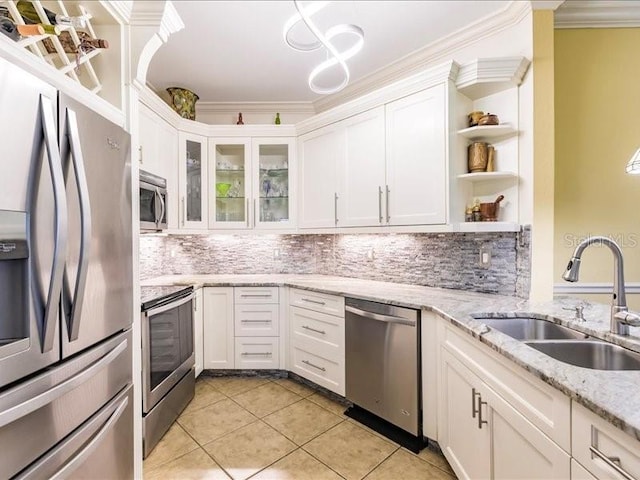 kitchen featuring stainless steel appliances, crown molding, white cabinetry, and sink