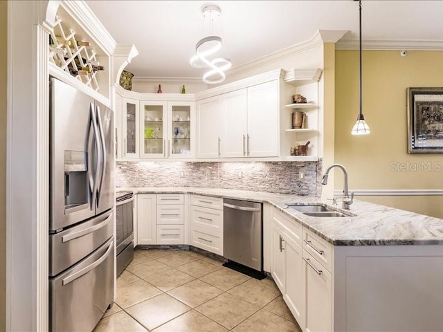 kitchen with appliances with stainless steel finishes, tasteful backsplash, sink, and white cabinets