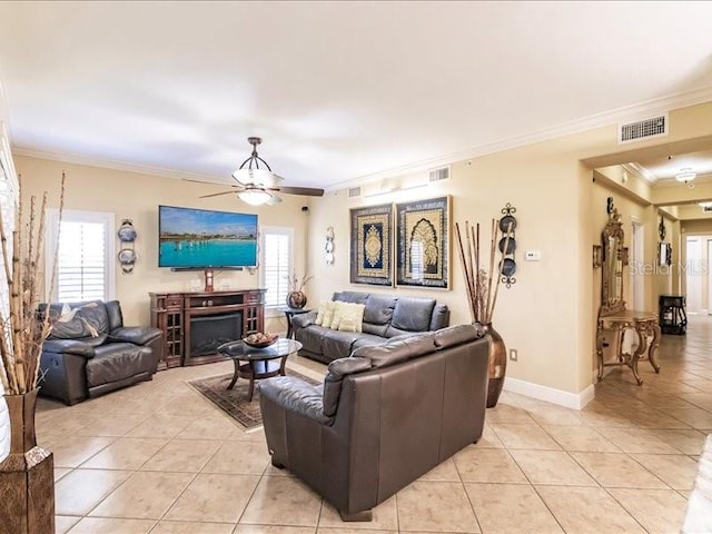 living room featuring ceiling fan, ornamental molding, and light tile patterned floors