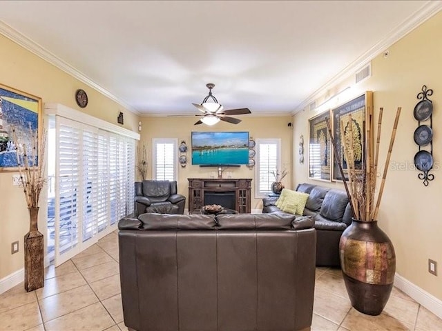 living room with ornamental molding, light tile patterned floors, and ceiling fan