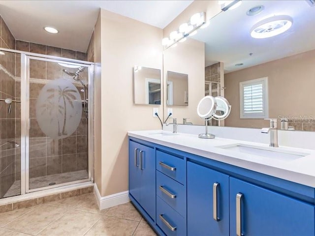 bathroom with a shower with shower door, tile patterned flooring, and vanity