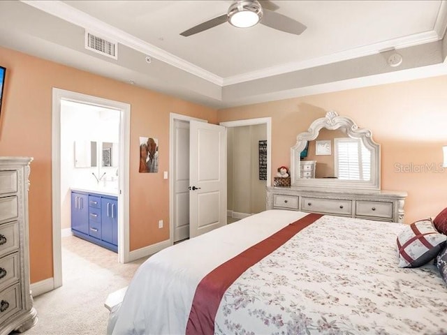 bedroom with crown molding, ensuite bath, ceiling fan, and light colored carpet