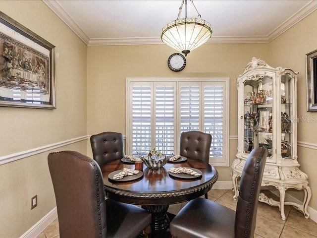 tiled dining room featuring ornamental molding