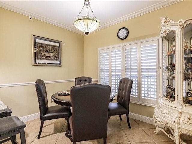 tiled dining area with ornamental molding and plenty of natural light