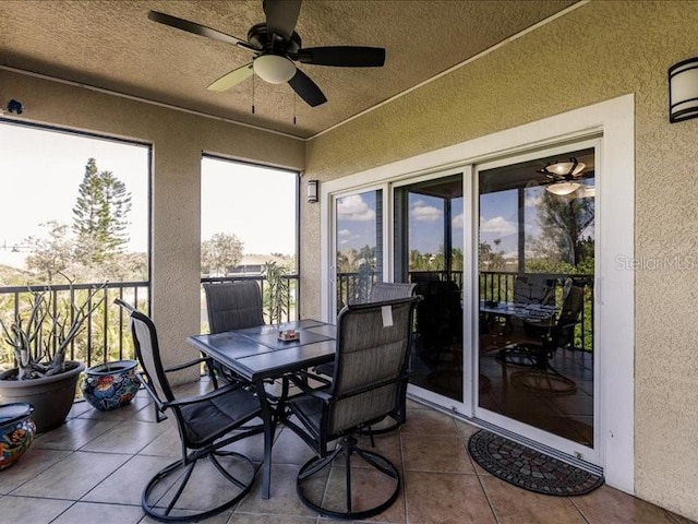 sunroom / solarium featuring ceiling fan