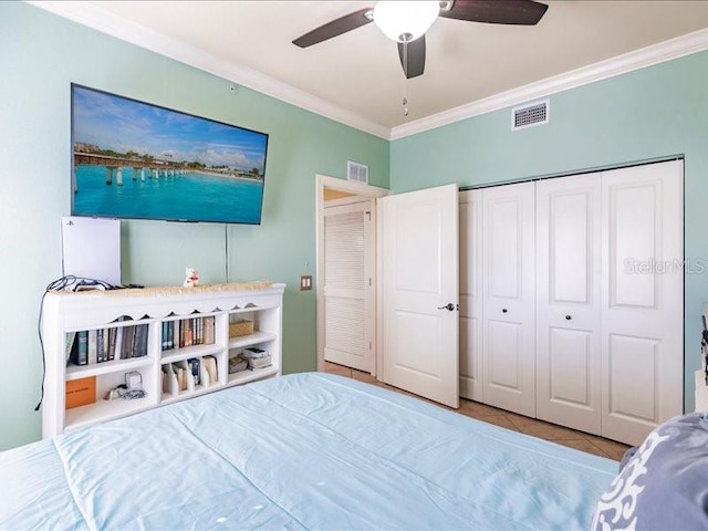 bedroom with a closet, ceiling fan, light tile patterned flooring, and ornamental molding