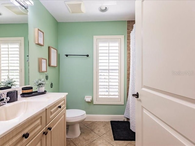 bathroom with vanity, toilet, curtained shower, and tile patterned floors