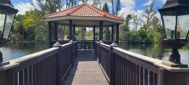 dock area with a gazebo and a water view