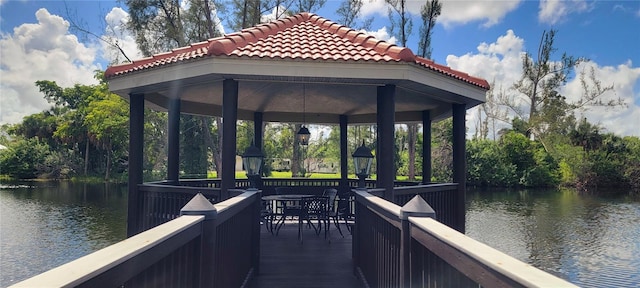 view of dock featuring a gazebo and a water view